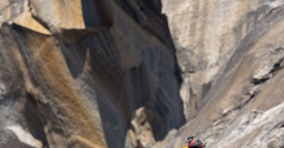 Mountain Conquest - Mountaineer Climbing a Rock