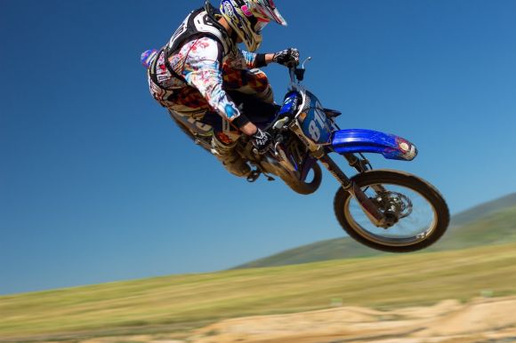 Thrilling Sports - man doing motorcycle air stunt during daytime