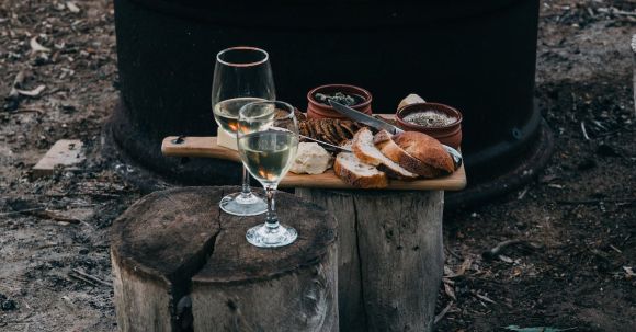 Cheese Board Perfection. - Fire near stumps and snack with glasses outside