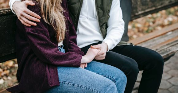 Date Attire - Crop anonymous tender young couple in casual stylish outfit cuddling and holding hands on wooden bench