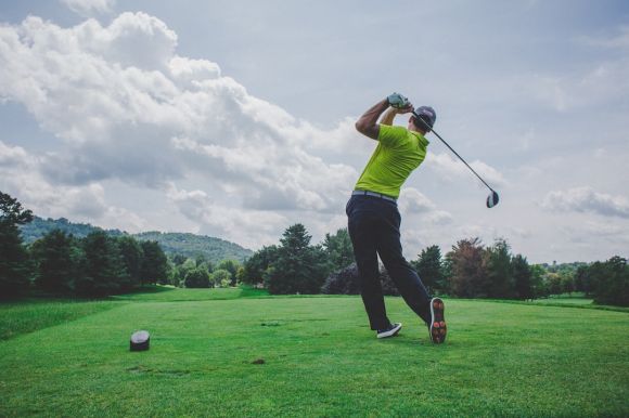 Golf - photo of man swinging golf driver