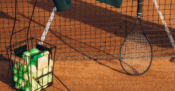 Tennis Elbow: Recovery - T-shirt, Racket and Balls on Tennis Court