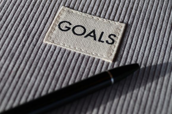Goal-setting - black and silver pen on gray textile