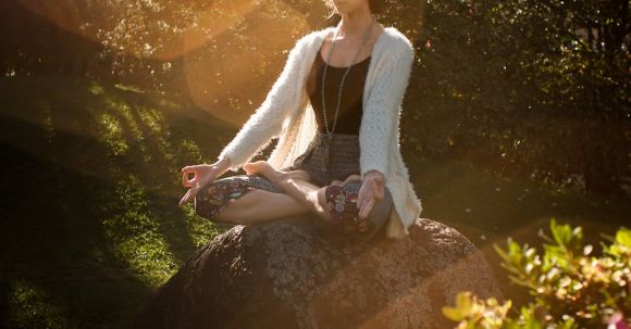 Total Fitness - Woman Meditating on Rock