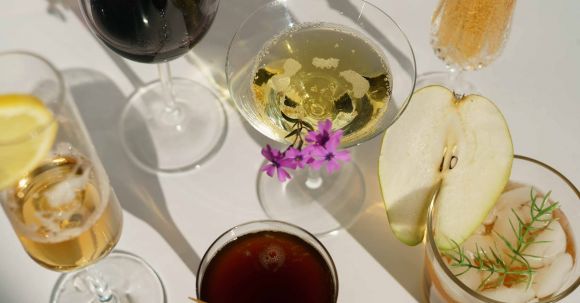 Classic Recipes - Glasses of cocktails decorated with pear and blooming flowers