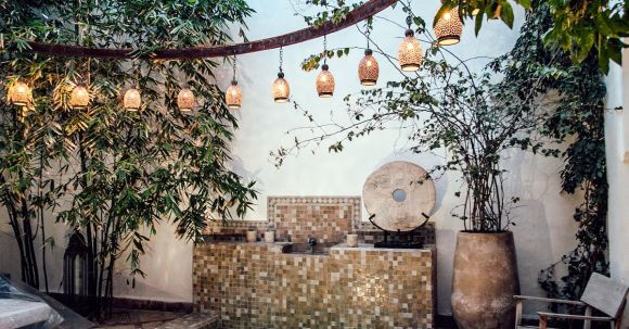 Authenticity, Values - Traditional oriental hammam pool on exotic resort spa terrace decorated with lush plants and stylish lanterns