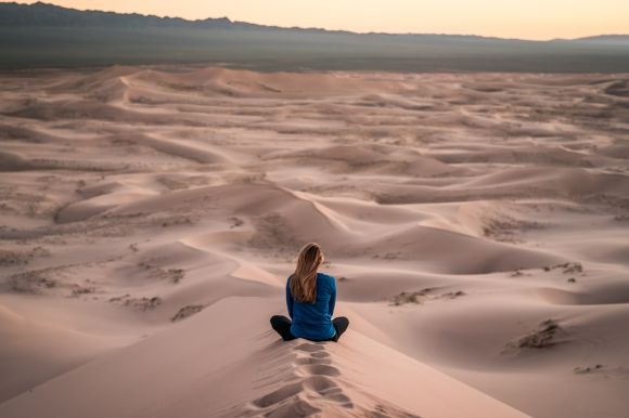 Self-reflection, Empowerment - woman sitting on sand field