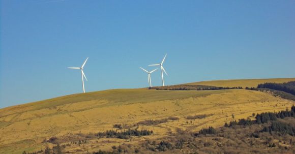 Technology Conservation - Three White Windmills on Green Field Under Blue Sky