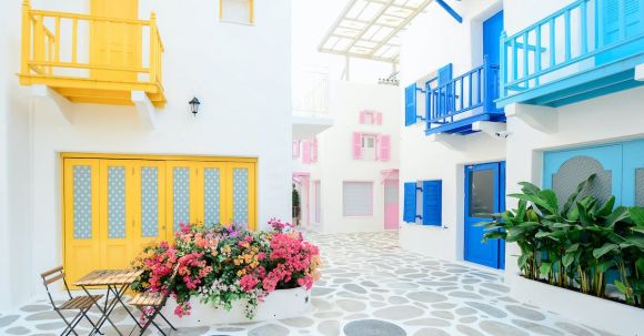 Mediterranean Delights - Architectural Photography of Three Pink, Blue, and Yellow Buildings