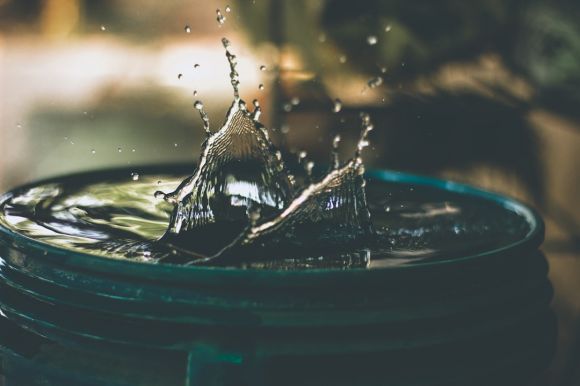 Water Conservation - water drop on bucket photo