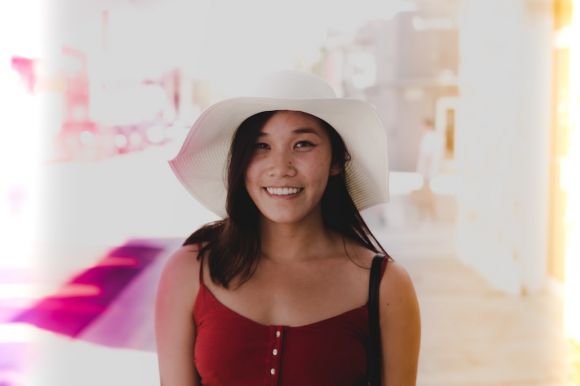 Fashion Tips - smiling woman wearing white sun hat